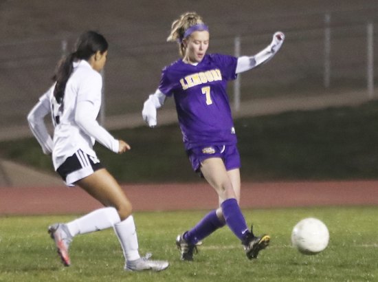Lemoore's Megan Ferreira keeps her eye on the ball in soccer action in Lemoore against visiting Tulare Union.